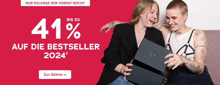 Werbemittel mit einer Rabattaktion von bis zu 41 % auf die Bestseller 2024. Auf der einen Seite ist der Hintergrund rot gestaltet mit der weißen Aufschrift: “Bis zu 41% auf die Bestseller 2024”. Oben ist ein weiß hinterlegtes Verknappungselement mit der Aufschrift: “Nur solange der Vorrat reicht”. Auf der anderen Seite ist ein Bild. Im Bild sitzen zwei lachende Personen auf einem Sofa. Eine Person trägt einen schwarzen Blazer, die andere ein weißes Top mit schwarzem, detailreichem Trägerdesign und Tattoos auf den Armen. Beide halten gemeinsam eine geöffnete schwarze Box und freuen sich. Am unteren Rand befindet sich ein Call-to-Action-Button mit der Aufschrift “Zur Aktion »”.